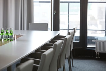 Chairs at conference table in modern office