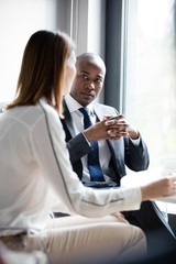 Young businessman with female colleague in office cafeteria