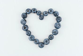 Blueberry heart on a white background copy space. Blue berry heart.