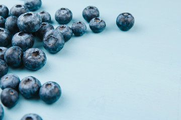  Ripe blueberries on a blue wooden background copy space. Harvest blueberries. Blue berry background.