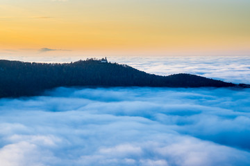 Germany, Magical aerial view above foggy cloudscape in valley of swabian jura nature landscape at...