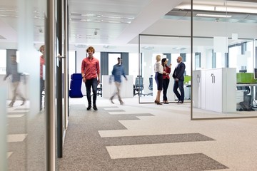 Businessmen and businesswomen in office corridor