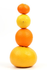 citrus fruit stand vertically on each other on white background