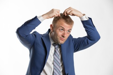 Young attractive businessman fixing his hair