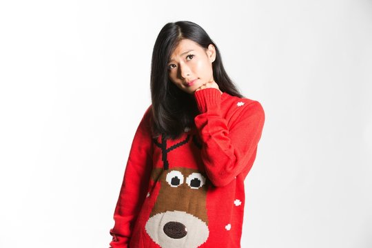 Young thoughtful chinese woman wearing christmas jacket