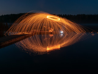 abstract light painting, long exposure, spiral of sparks being thrown out in all directions