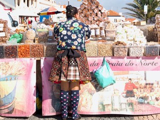 Traditional portuguese woman wearing a skit with 7 petticoats in Nazare in Portugal