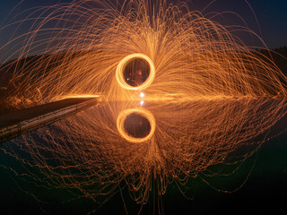 abstract light painting, long exposure, spiral of sparks being thrown out in all directions