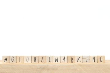 wooden cubes with a hashtag and the word Global warming, social media concept near white background