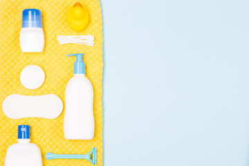Woman bath face body care morning routine top view flat lay composition with white and blue items on light blue desk