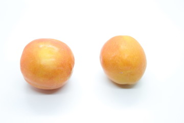 Ripe plum located on a white background