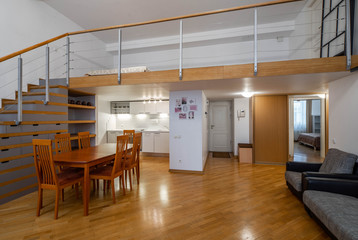 Modern interior of studio apartment. Kitchen set. Wooden table. Cozy couch.