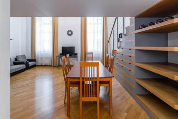 Modern light interior. Wooden furniture and shelves. Staircase. Studio apartment.