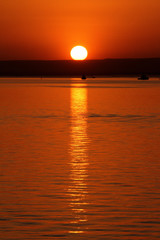 Orange sky during a sunset in the Ionian Sea seen from the city of Taranto