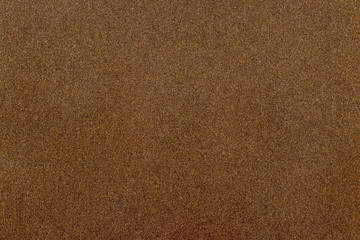 Fototapeta na wymiar Abstract grainy background. A rectangular piece of sandpaper_