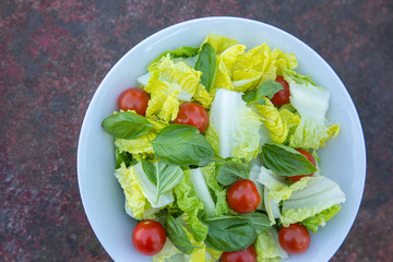 Healthy vegetarian vegan lunch dinner salad bowl  tomato, green vegetable vegetables Top View From Above on a rusty metallic table background