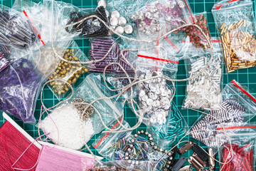 various embroidery items on cutting mat close up