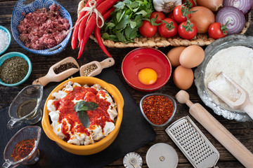 Turkish ravioli manti preparation with meat, yoghurt, butter and red pepper. Mantı concept stock photo. 