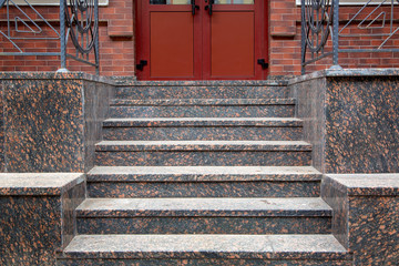 marble staircase with a rise to the front door, threshold with steps entrance close up front view.