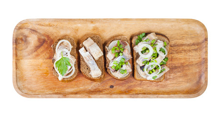 top view of various open sandwich with herring