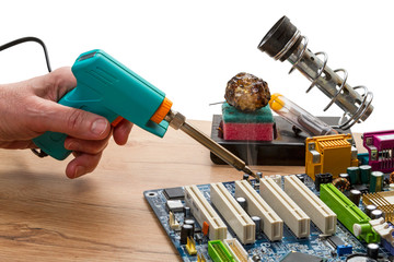 Hand with a pulse soldering iron solder