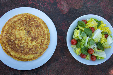 Traditional Spanish potatoes tortilla omelette with salad on a rusty table delicious food tapa tapas eat eating  healthy