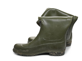 Dirty green rubber boots for hunting, fishing isolated on white background
