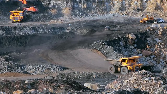 Coal mining in quarry, panorama yellow dump truck carries coal