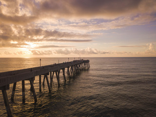 Fototapeta na wymiar aerial view of Ocean and wooden pier at sunrise