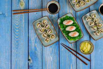 Set of sushi roll with soy sauce, ginger and chopstick. Japanese cuisine.