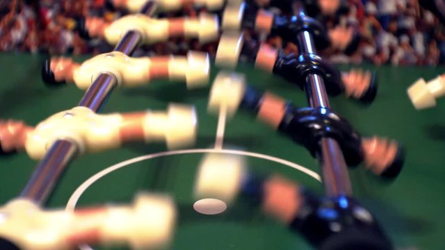 foosball.small plastic players in the table soccer.game kicker close up.Shallow depth of field.