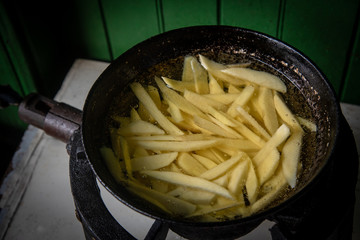 French fries potatoes boiled and cooked on oil.
