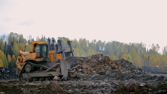  panorama Yellow tracked bulldozer moves your bucket stones