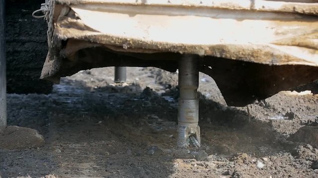 Close-up drilling machine prepares well for explosives