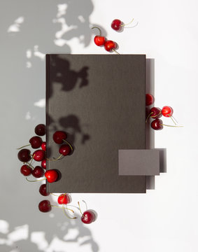 Grey Business Card And Black Folder With Cherries