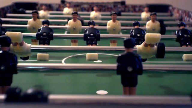Games, entertainment, hobbies and leisure. Football for the kicker with miniature players. Foosball with plastic figures. Indoor table football - a game in the office. Close-up. Shallow depth of field