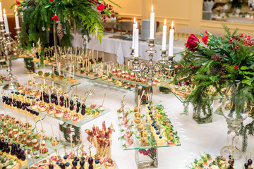 Catering. Off-site food. Buffet table with various canapes, sandwiches, hamburgers and snacks.
