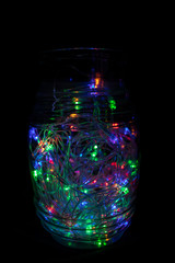 Glass jar with a luminous electric garland