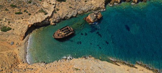Aerial drone ultra wide photo of iconic rusty shipwreck in Amorgos island, Cyclades, Greece