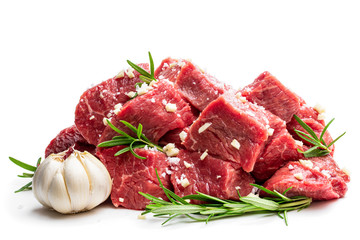 Sliced raw beef with rosemary herb and garlic isolated on white