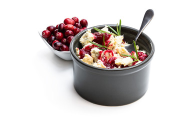 Potted aged Blue stilton cheese with cranberry sauce isolated on white