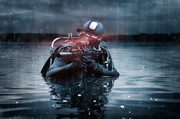 SWAT unit soldier stands waist-deep in water with a machine gun in his hands. The concept of video...