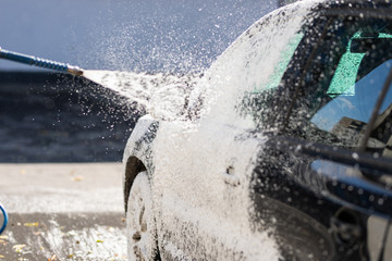 Man washes foam machine. Carwash. Washing machine at the station