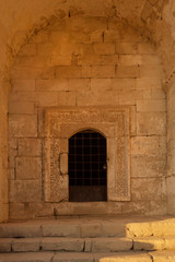 Fototapeta na wymiar Entrance to medieval mausoleum of Princess Dzhanike Khanym, daughter of Golden Horde Khan Tokhtamysh, in ancient cave city Chufut Kale, Crimea