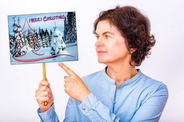 Woman holds sign with Christmas greetings