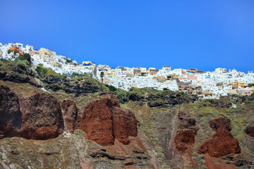 The coast of the Greek island of Santorini with the cliff towns of Oia and Thira