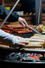Street food at the main city fair Kebab, corn, grilled sausages.