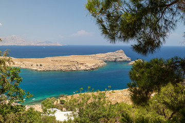 Fototapeta premium Scenic view from the acropolis on a bay with blue and turquoise water in Lindos on Rhodes island, Greece