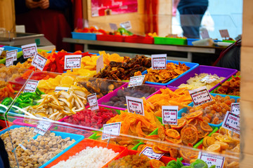 colorful candied fruit in the foreground at a stall