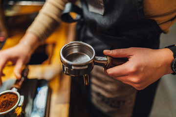 Barista making coffee from espresso machine in coffee shop
